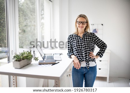 Woman working at a standing desk in office