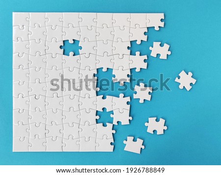 White jigsaw puzzle on blue background Royalty-Free Stock Photo #1926788849