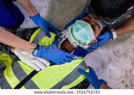 First aid for head injuries and Considered for all trauma incidents of worker in work, Loss of feeling or loss of normal movement and Loss of function in limbs, First aid training to transfer patient. Royalty-Free Stock Photo #1926792143