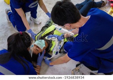First aid for head injuries and Considered for all trauma incidents of worker in work, Loss of feeling or loss of normal movement and Loss of function in limbs, First aid training to transfer patient. Royalty-Free Stock Photo #1926838934
