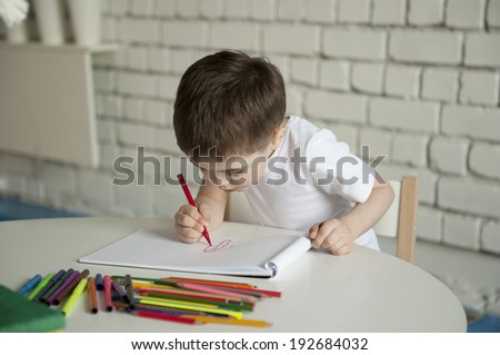 little boy draws