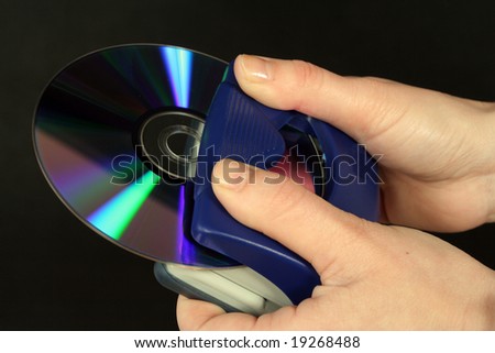 CD and stapler in the hands