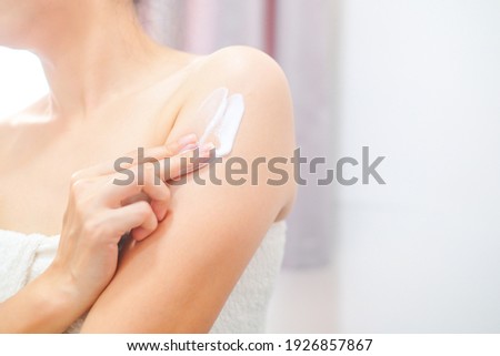 Woman applying natural cream, Woman moisturizing her arm with cosmetic cream, Spa and Manicure concept. Royalty-Free Stock Photo #1926857867