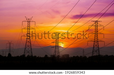 High voltage pole on silhouette sunset background Royalty-Free Stock Photo #1926859343