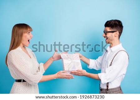 Photo of shocked impressed two persons dressed white clothes giving present isolated blue color background