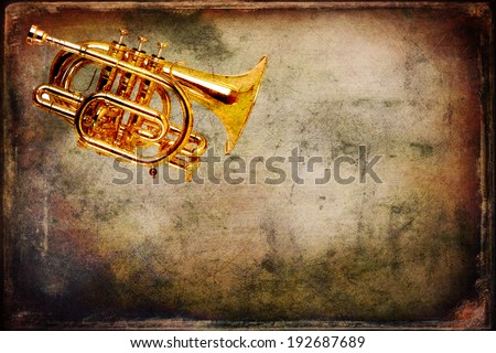 Old trumpet photo on the grunge background
