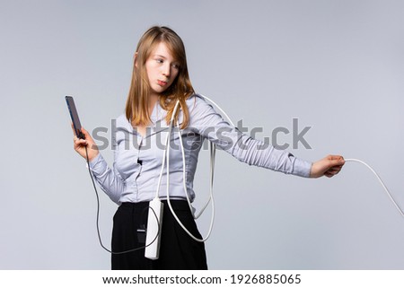 Woman wired to smartphone, network addicted to mobile device, addicted to social media, internet technology, addiction. Online prisoner Royalty-Free Stock Photo #1926885065