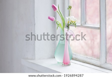 pink tulips on old white windowsill