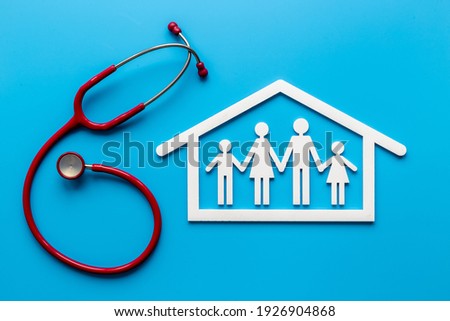 Family figure in house frame with stethoscope. Medical care concept