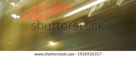 Long exposure photography. Traffic. Blurred motion of cable car. Soft green, red and brown colors in the fog. Long exposure image. Defocused image. 