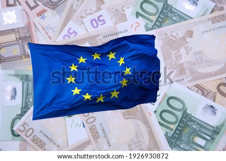Eu flag with euro banknotes. Concept finance