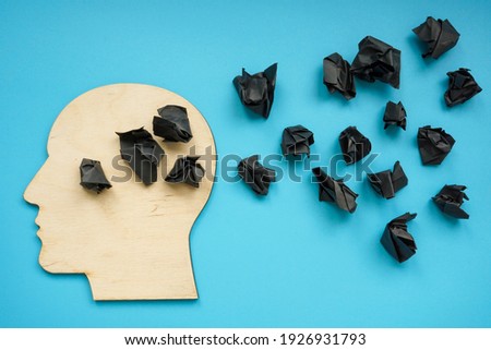 Head shape with black paper balls as symbol of depression and negative thoughts. Royalty-Free Stock Photo #1926931793