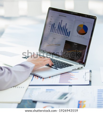 Close up Business woman using calculator and laptop for do math finance on wooden desk, tax, accounting, statistics and analytical research concept Royalty-Free Stock Photo #1926943559