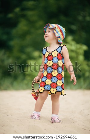 Cute little girl with bright colorful dress
