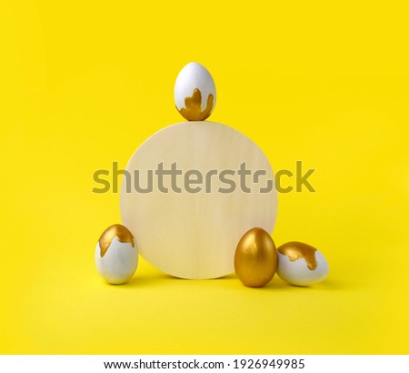 Mock up Easter composition with golden painted eggs and geometric shape on yellow background. Minimalist concept for greeting card or sale. Creative eco  design. 