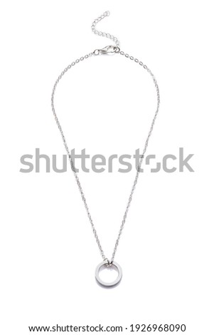 Subject shot of elegant silver necklace with flat silver ring. The adjustable necklace with lobster clasp and extension chain is isolated on the white background. Royalty-Free Stock Photo #1926968090