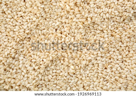 Pile of white sesame seeds as background, top view Royalty-Free Stock Photo #1926969113