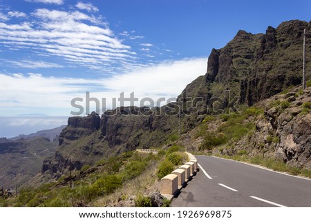 Landscape photograph of mountains, plants and a road on 
 the island Tenerife, Spain