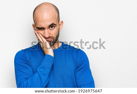 Young hispanic man wearing casual clothes thinking looking tired and bored with depression problems with crossed arms.  Royalty-Free Stock Photo #1926975647