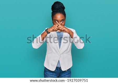 Young african american woman wearing business clothes rejection expression crossing fingers doing negative sign 