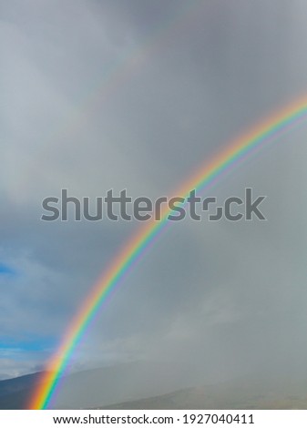 Rainbow and rainy clouds in the sky
