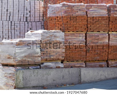 pallets with white and red bricks in the building store. Racks with brick. nobody