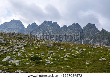 Beautiful sharp rocky peaks of mountain ranges under cloudy sky in the High Tatras, Slovakia