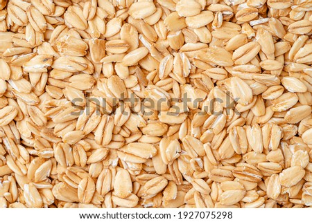 Rolled oat, oat flakes background or texture. Close up, directly above. Royalty-Free Stock Photo #1927075298