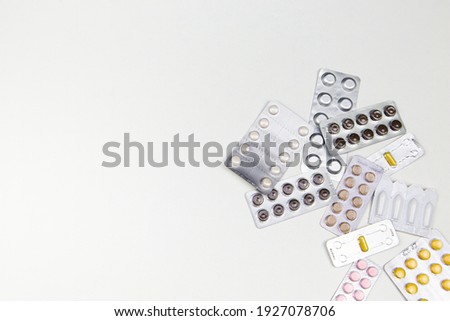 many different medicines in tablets and capsules on a white background