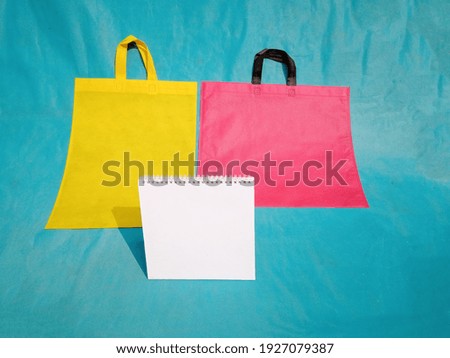 Table Calendar Mockup with Shopping ECO Bags Isolated on Blue Background. Copy Space for Text Logo.