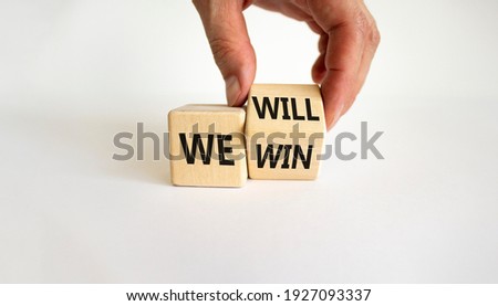 We will win symbol. Businessman turns cubes and changes words we will to we win. Beautiful white background, copy space. Business, motivational and we will win concept. Royalty-Free Stock Photo #1927093337