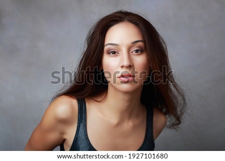 Portrait of beautiful young woman shows angry emotion