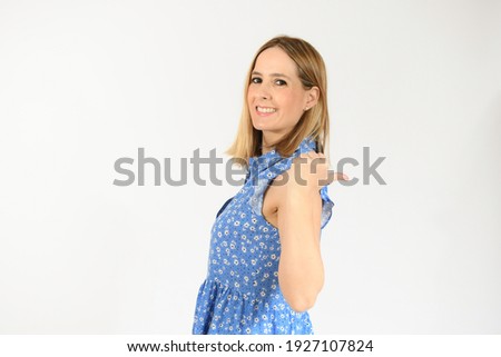 Young woman over isolated white background pointing finger to the side