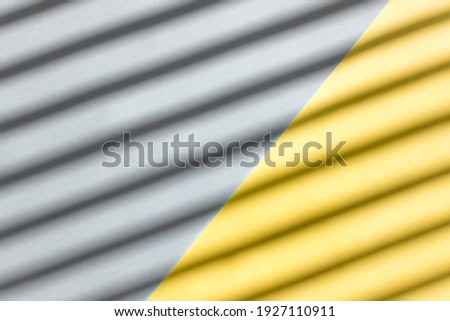 Abstract background from yellow and gray color with diagonal shadows on it