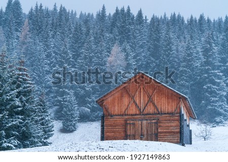 Snowing in autumn on a mountain cabin in Corvara in Badia village of Dolomites mountain range of Italy, Europe, Unesco World Heritage Site