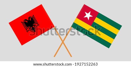 Crossed flags of Albania and Togo. Official colors. Correct proportion