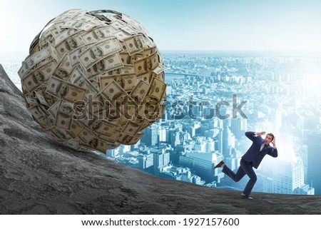 Businessman running away from dollar ball Royalty-Free Stock Photo #1927157600