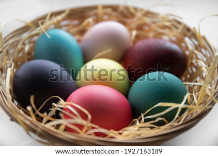 Easter eggs in a wicker basket with straw