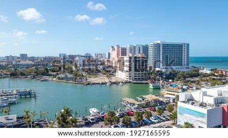 Clearwater Beach FL. Dock of the bay for boats, yacht, powerboat. Ocean or shore Gulf of Mexico. Spring break or Summer vacations in Florida. Hotels, restaurants and Resorts. Tropical Nature.