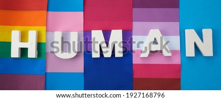 Zero Discrimination Day. Different rainbow flags with human word. Royalty-Free Stock Photo #1927168796