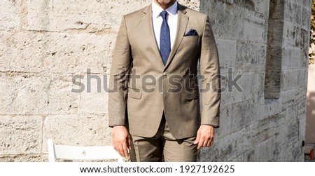 green tone male suit on a mannequin combined different poses old Gothic style photographed in front of the stone wall fashion trend Textile male lifestyle business man buying. 