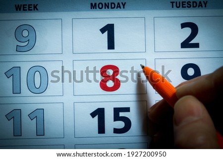 Part of calendar for March, 2021 with pen, office background