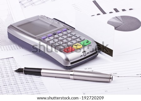 Business still-life of tables, payment terminal, credit Cards, eyeglasses, ink pen
