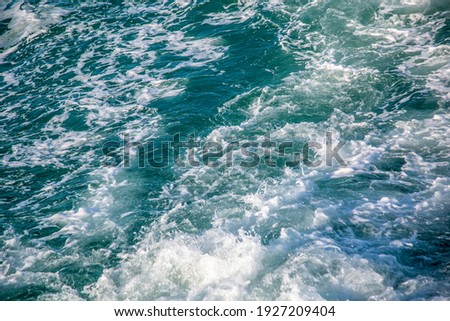 Blue sea with waves and foam, the scenery is in the middle of the ocean