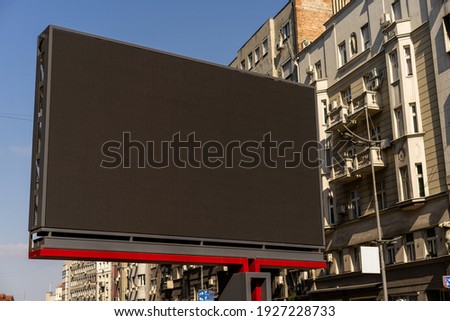 Blank billboard in an urban area on a sunny day
