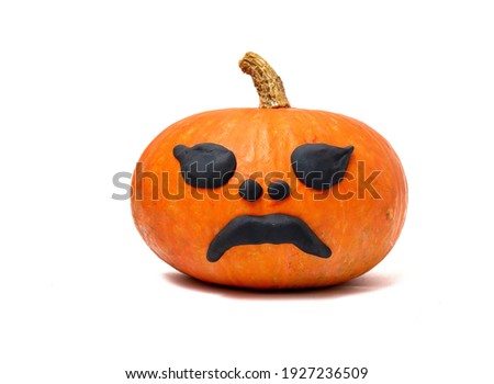 Lonely orange yellow pumpkin on white background, sad face decoration.