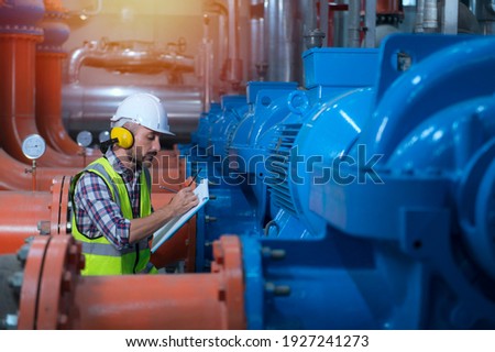Mechanical engineer Checking of centrifugal pump in pump room. worker working in plant room. Royalty-Free Stock Photo #1927241273