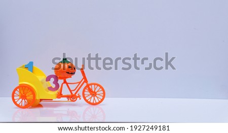  Design Cute pumpkin devil on a tricycle is transporting number 13