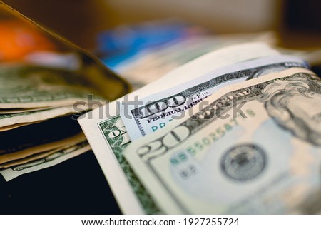 Money, US dollar banknotes background. Money scattered on the desk. Close-up photo. Finance and Economy concept. 