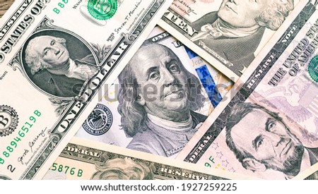 Money, US dollar banknotes background. US dollar bills scattered on a table. Close-up photo. Finance, Business and Economy concept.  Royalty-Free Stock Photo #1927259225